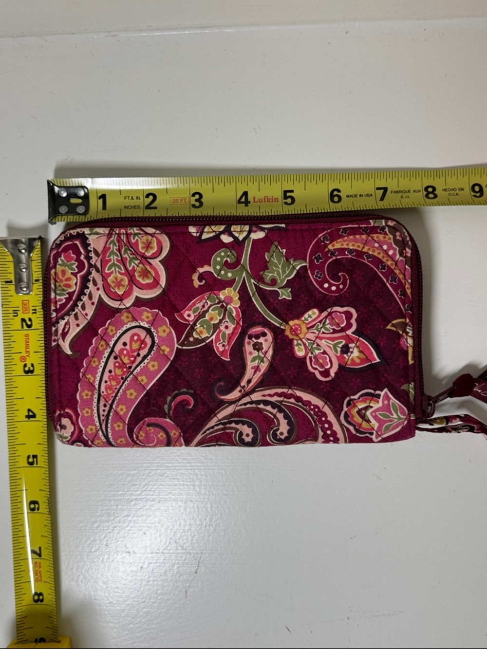 Vera Bradley burgundy and pink paisley fabric wallet with wrist strap.